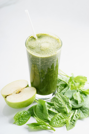 Fresh green juice smoothie made with organic green fruits and vegetablesの写真素材