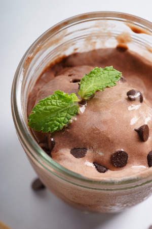 chocolate ice cream in a cup with chocolate chipの写真素材