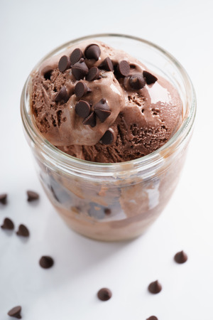 chocolate ice cream in a cup with chocolate chipの写真素材