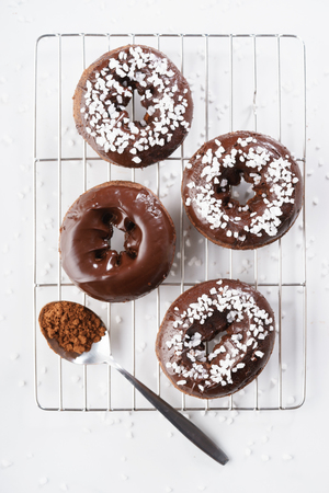 Sweet pieces of chocolate doughnuts with chocolate coatingの写真素材