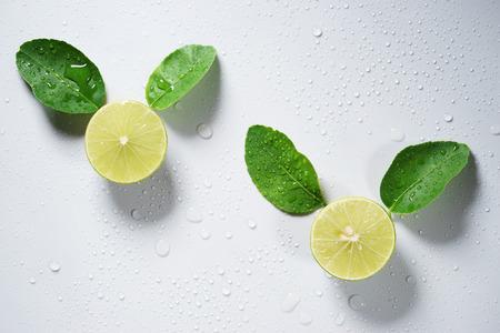 fresh limes with slice and leaves