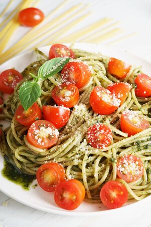 Pasta spaghetti with pesto sauce, fresh basil and cherry-tomatoesの写真素材