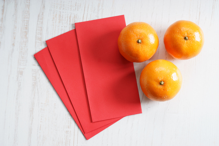 Chinese new year festival decorations, ang pow or red packets and mandarin orangesの写真素材