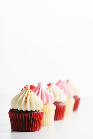 colorful cupcakes, red and pink, with buttercream and heart figure candy. love concept.の写真素材