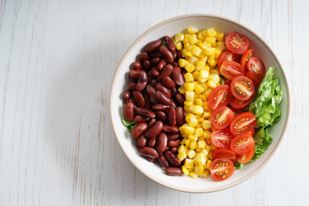 southwestern colorful salad with boiled red bean and sweet corn and sliced fresh tomatoの写真素材