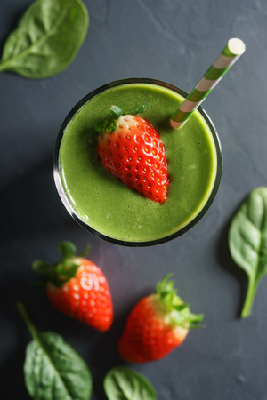 healthy green smoothie with spinach and fresh strawberryの写真素材