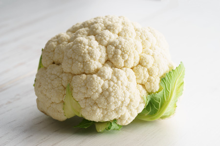 fresh white cauliflower on wooden tableの写真素材