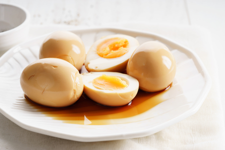 Boiled eggs in black soy sauceの写真素材