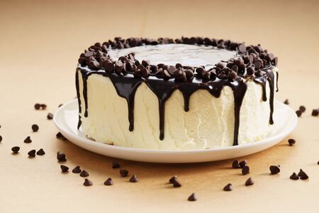 round cake with white buttercream topped with chocolate coatingの写真素材