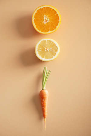 fresh orange tone vegetables on color backgroundの写真素材