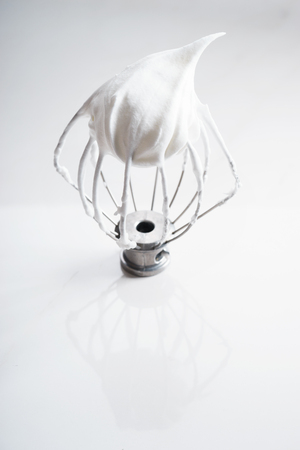 Whipped egg whites on electric whisk, baking ingredientの写真素材