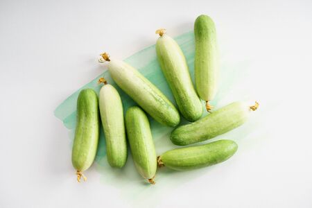 fresh cucumber on painted green color backgroundの写真素材
