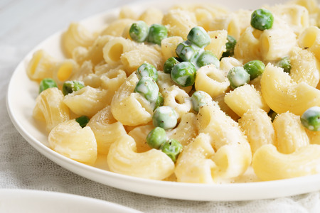 Fusilli pasta with green peas and herbsの写真素材