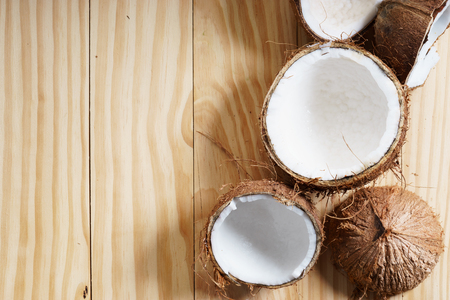 coconut with brown shell on wooden background