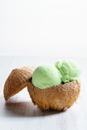 lime ice cream scoops, green color ice cream,on coconut hard shell cupの写真素材