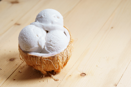 coconut ice cream scoops on coconut cupの写真素材