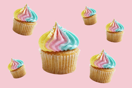 cupcakes with rainbow buttercream on pink color background. clipping path.の写真素材
