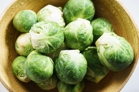 overhead view of brussels sprouts in wooden bowlの写真素材