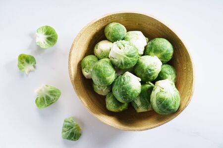 overhead view of brussels sprouts in wooden bowl