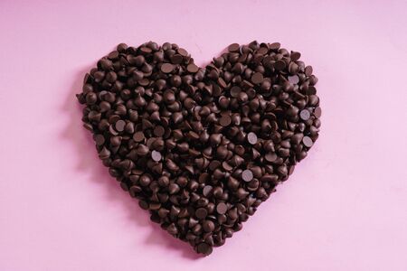 heart shaped chocolate chip for valentines concept on pink background