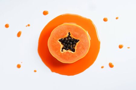 papaya fruit abstract in orange watercolor on white background. freeform shape around sliced object. top view.の写真素材