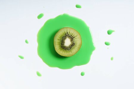 kiwi fruit abstract in green watercolor on white background. freeform shape around sliced object. top view.の写真素材