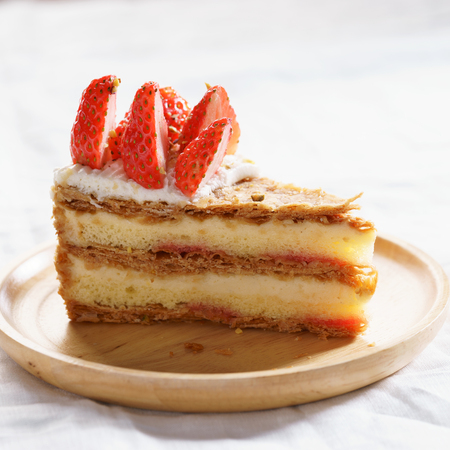 layered cake with fresh strawberry and cream, closeup