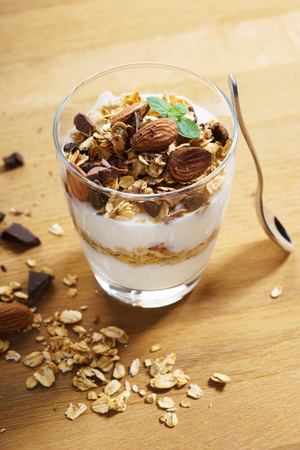 Yogurt Parfait with oat granola and chopped chocolateの写真素材