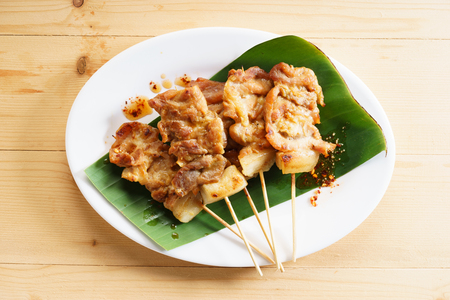 grilled pork kebabs with coriander leaves and chili sauceの写真素材