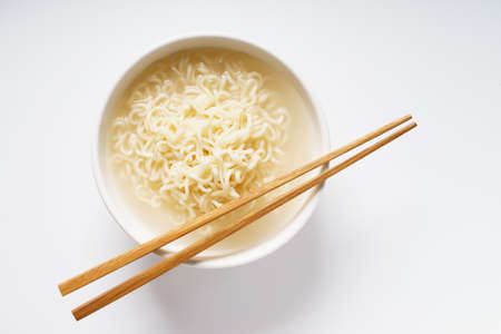 Instant noodle in white bowl with wooden chopstick