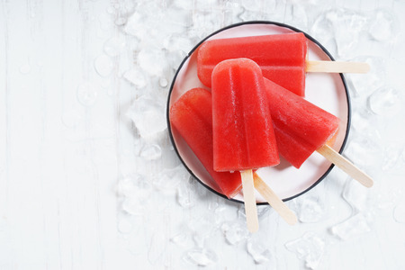 homemade watermelon ice lolly on white plateの写真素材
