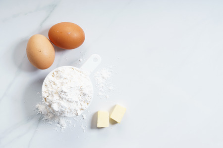 flour in white cup with egg, cooking conceptの写真素材