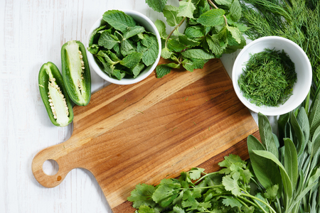fresh green herbs and wooden plankの写真素材