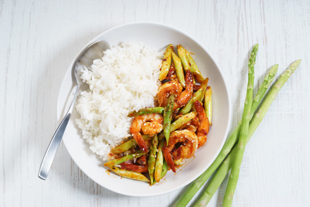 Prawn meat with spicy sauce and asparagus served with riceの写真素材