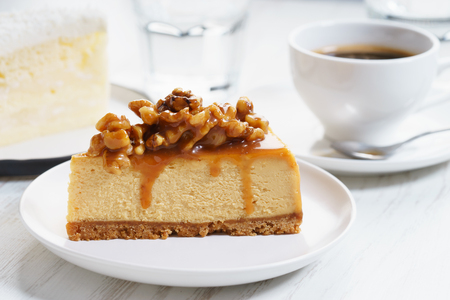 caramel cheese cake with coffee on white wooden tableの写真素材