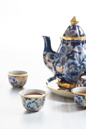 Porcelain teapot in classic style on blue colorの写真素材