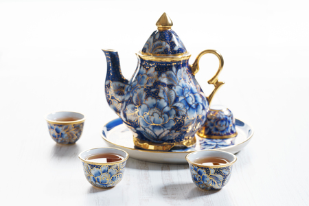 Porcelain teapot in classic style on blue colorの写真素材
