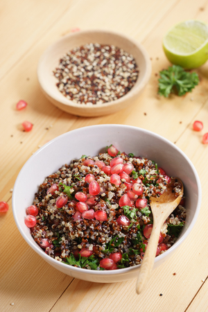 quinoa salad with pomegranate and lime, healthy food.の写真素材