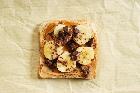 healthy whole wheat toasted bread with peanut butter and sliced bananaの写真素材