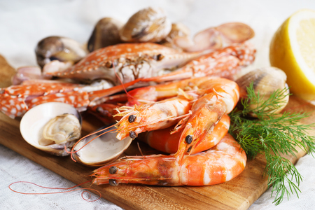 Crustacean seafood with lemon and drill on wooden tableの写真素材