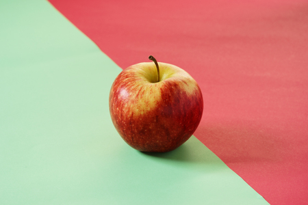 Red apple on green and red colorの写真素材