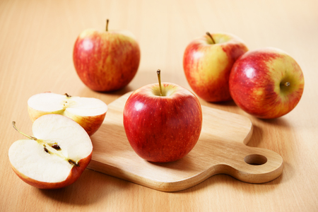 Red apples on wooden tableの写真素材