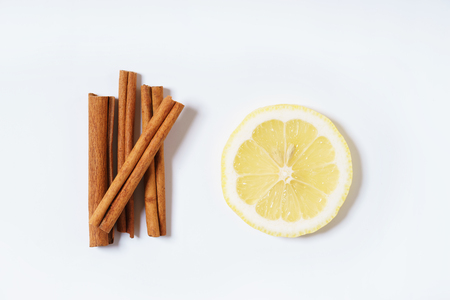 Cinnamon sticks and lemon on whiteの写真素材