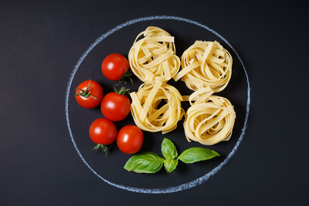 Pasta, tomatoes and sweet basil, pasta ingredient. Cooking conceptの写真素材