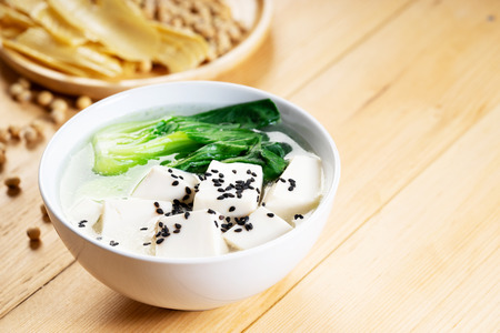 Tofu soup with vegetable on wooden backgroundの写真素材