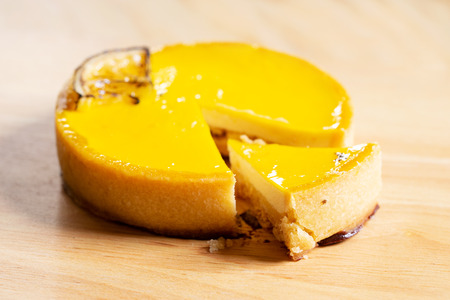 Lemon tart cut to small piece on wooden backgroundの写真素材