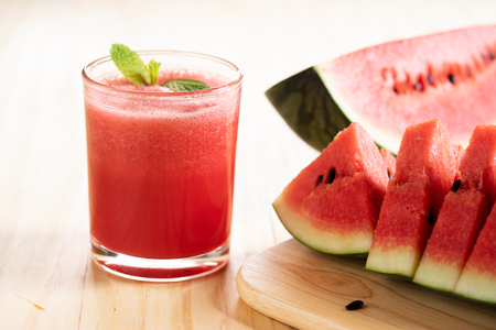 Watermelon sliced and watermelon smoothie on wooden backgroundの写真素材