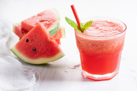 Watermelon smoothie with mint and fresh watermelon slicesの写真素材