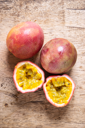 Ripe passion fruit on wooden background, top viewの写真素材
