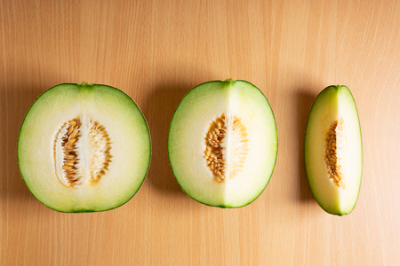 Fresh green melon slices on woodenの写真素材